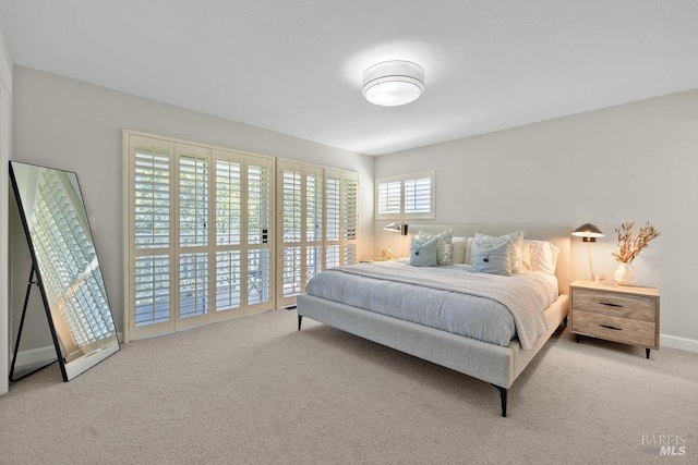 bedroom with baseboards, access to outside, and carpet flooring