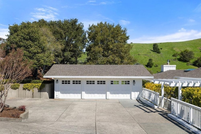 detached garage featuring fence