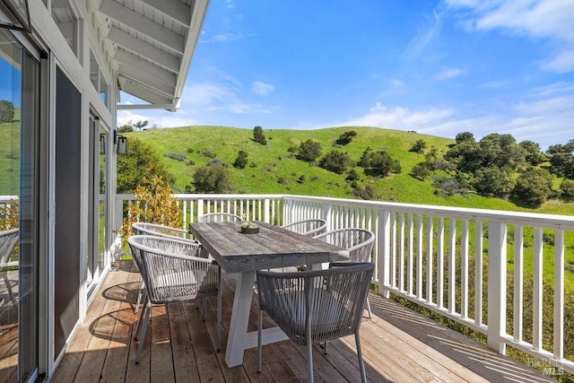 deck featuring a water view and outdoor dining space
