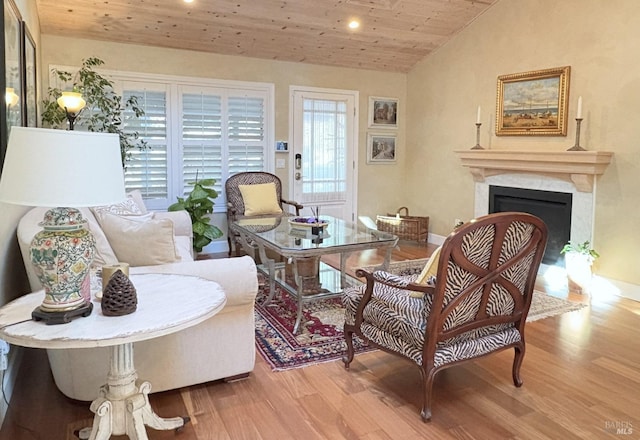 sitting room featuring recessed lighting, lofted ceiling, wood finished floors, wooden ceiling, and a fireplace