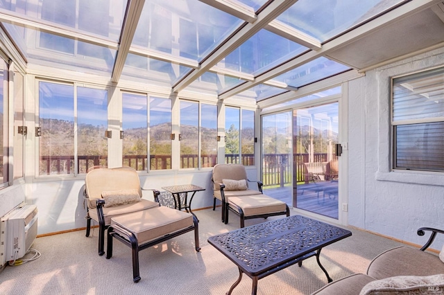 sunroom / solarium with a mountain view, beam ceiling, and coffered ceiling