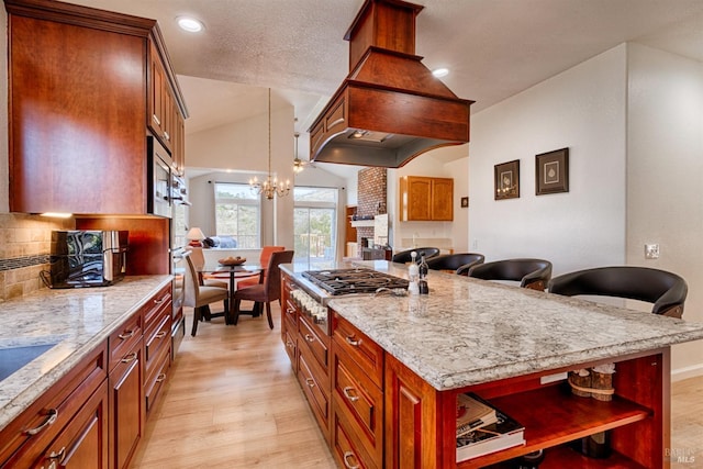 kitchen with light wood-type flooring, a chandelier, open shelves, stainless steel gas cooktop, and lofted ceiling