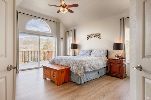 bedroom featuring light wood finished floors, access to outside, ceiling fan, and lofted ceiling