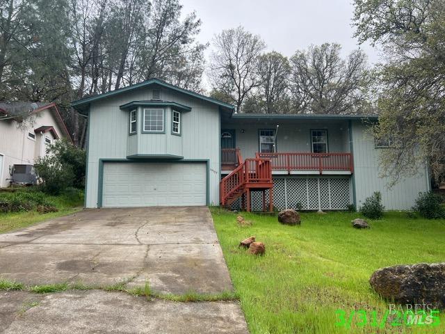 19557 Donkey Hill Rd, Hidden Valley Lake, CA 95467 - single story home with a front yard, an attached garage, covered porch, stairs, and driveway