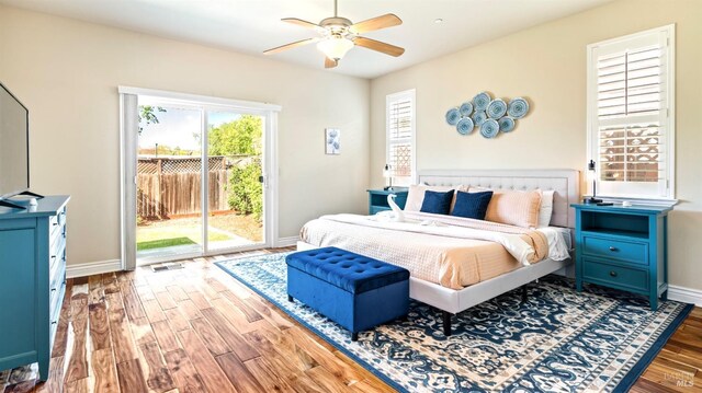bedroom featuring access to outside, baseboards, ceiling fan, and wood finished floors
