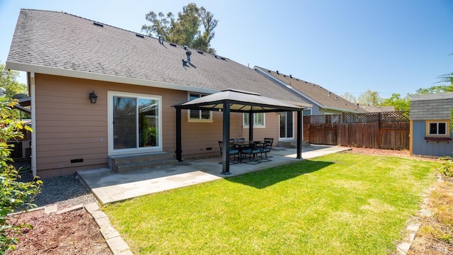 back of house with fence, a patio, a gazebo, and a lawn