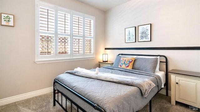 carpeted bedroom featuring baseboards