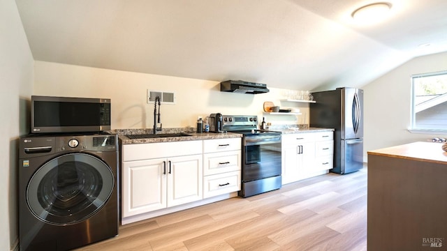 washroom with a sink, light wood-type flooring, washer / clothes dryer, and visible vents