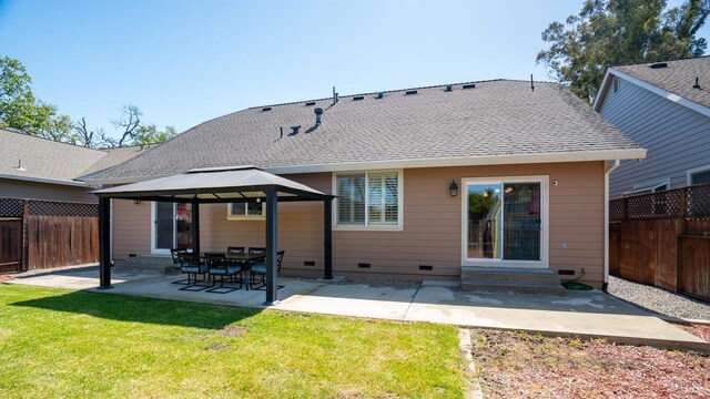 back of house with a yard, crawl space, a gazebo, and a fenced backyard
