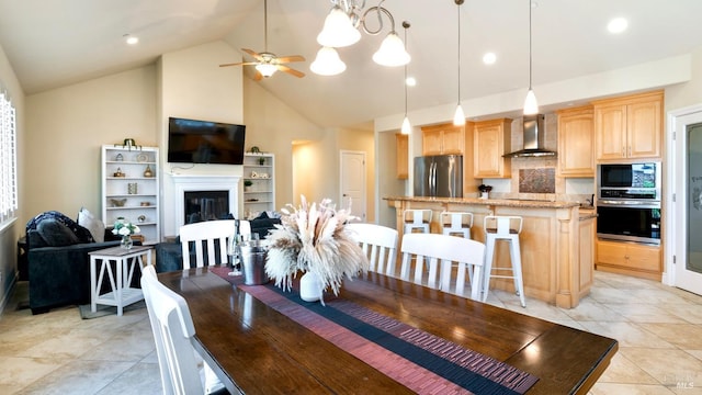 dining area with recessed lighting, a glass covered fireplace, ceiling fan, and high vaulted ceiling