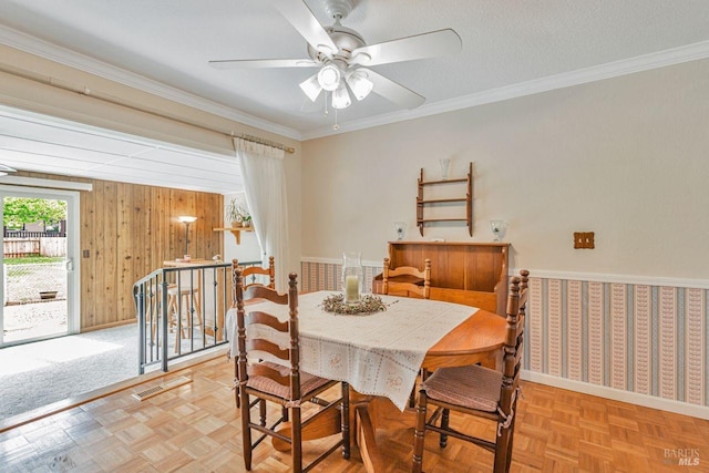 dining room featuring ornamental molding, baseboards, and a ceiling fan
