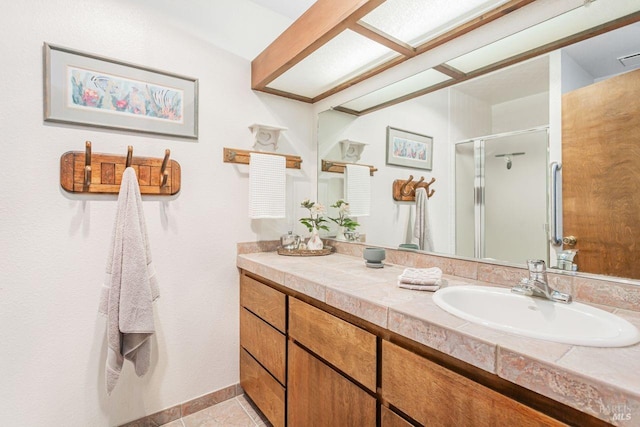 full bathroom featuring tile patterned floors, vanity, and a stall shower