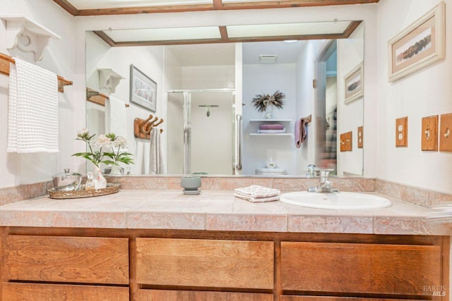 bathroom featuring vanity, visible vents, and a stall shower
