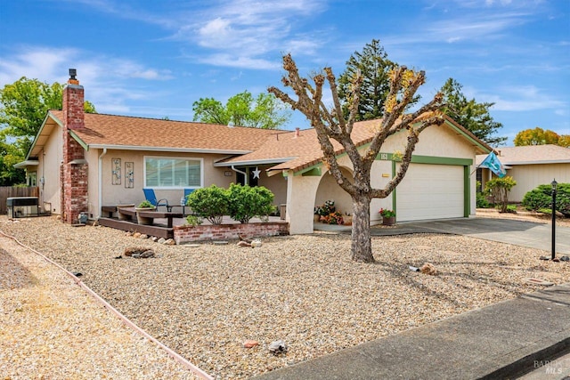 single story home with concrete driveway, stucco siding, a chimney, and an attached garage