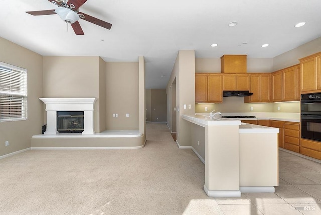 kitchen featuring ceiling fan, dobule oven black, recessed lighting, under cabinet range hood, and light countertops