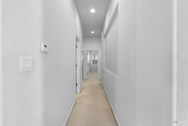 corridor with baseboards and recessed lighting