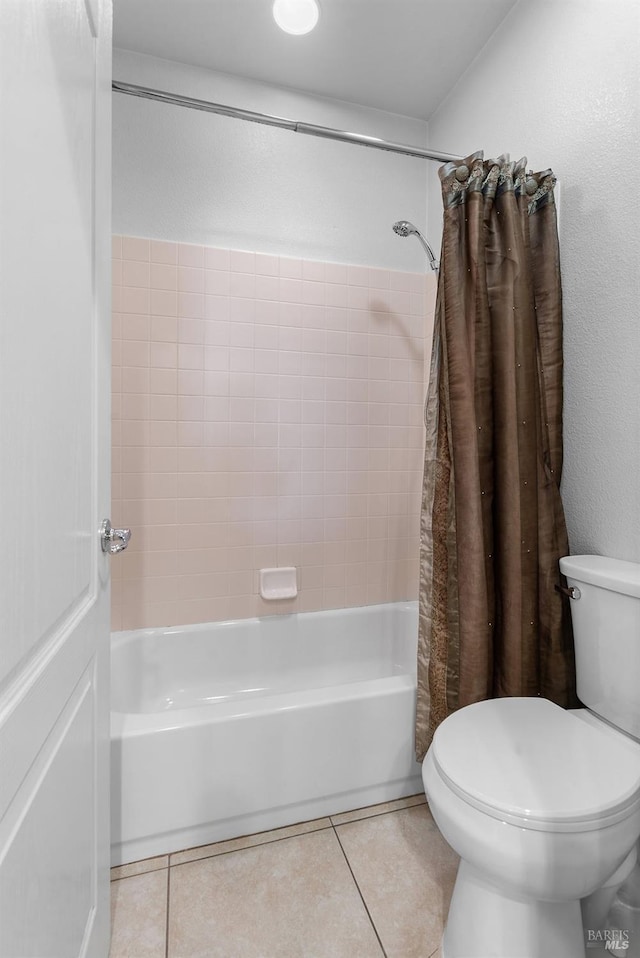 bathroom with shower / bath combo, toilet, and tile patterned flooring
