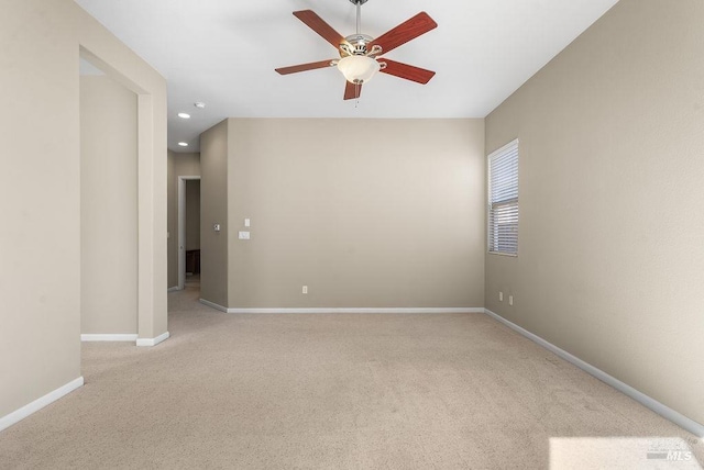 empty room with recessed lighting, light colored carpet, baseboards, and a ceiling fan