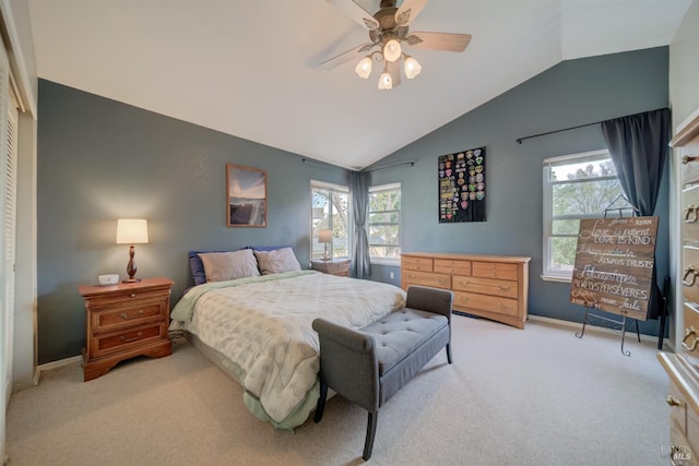 bedroom with baseboards, multiple windows, vaulted ceiling, and light carpet