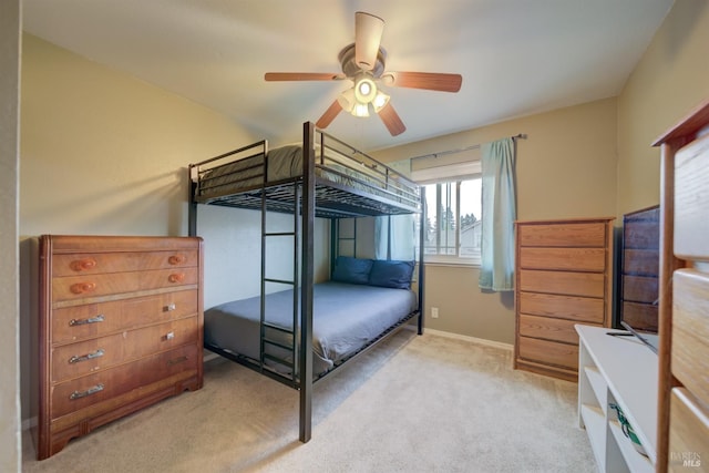 bedroom featuring light carpet, baseboards, and a ceiling fan