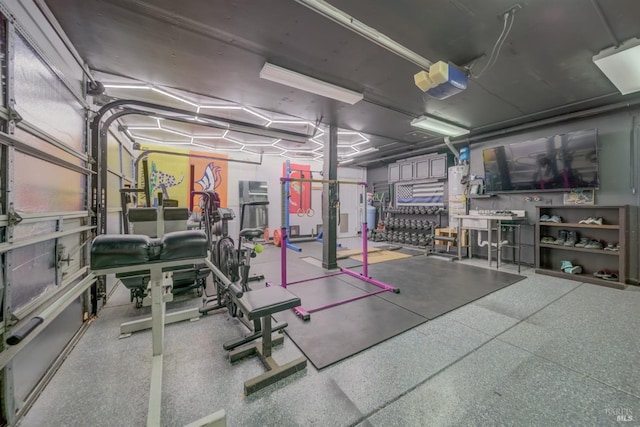 workout room with a garage and water heater
