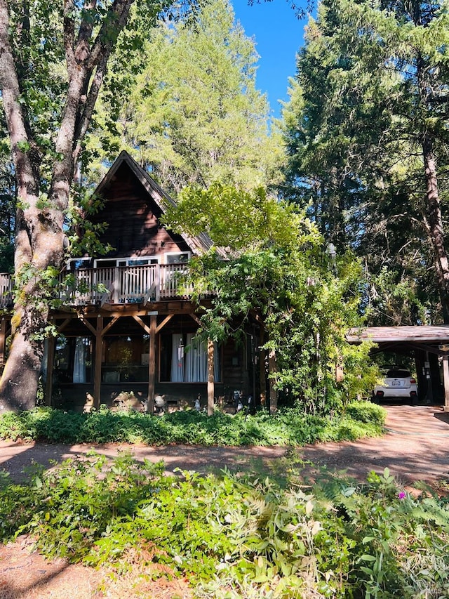 view of front of home featuring a carport and a deck