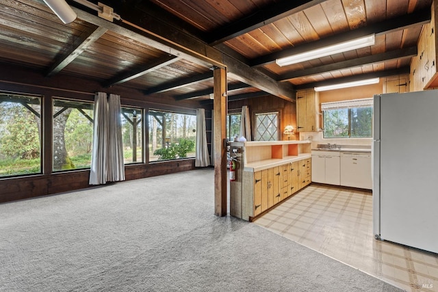 kitchen featuring white appliances, light countertops, beam ceiling, light floors, and wooden ceiling
