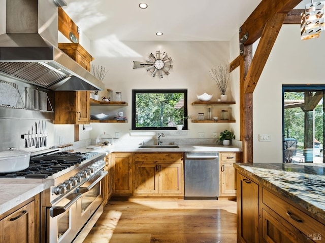 kitchen with open shelves, a sink, wall chimney range hood, recessed lighting, and stainless steel appliances