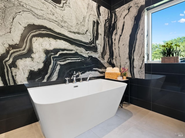 full bathroom with tile patterned floors and a freestanding tub