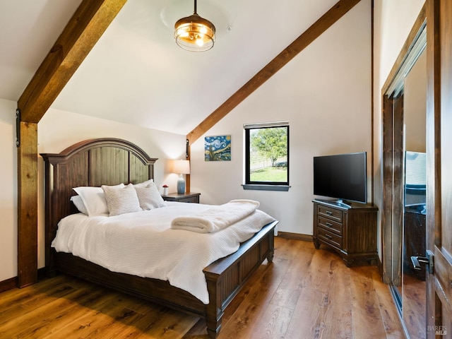 bedroom with vaulted ceiling with beams, baseboards, and hardwood / wood-style floors