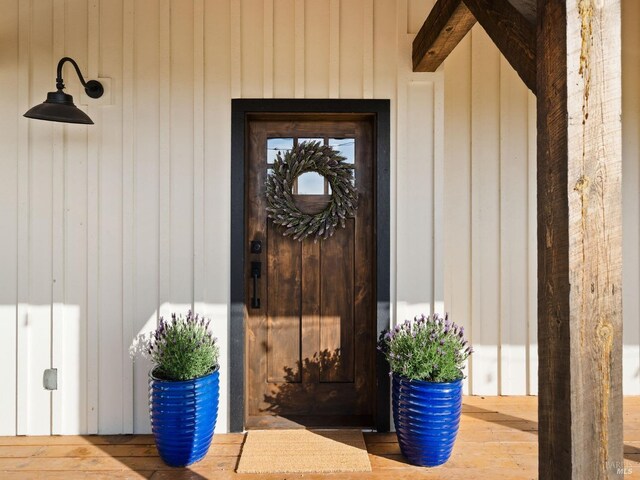 doorway to property featuring board and batten siding