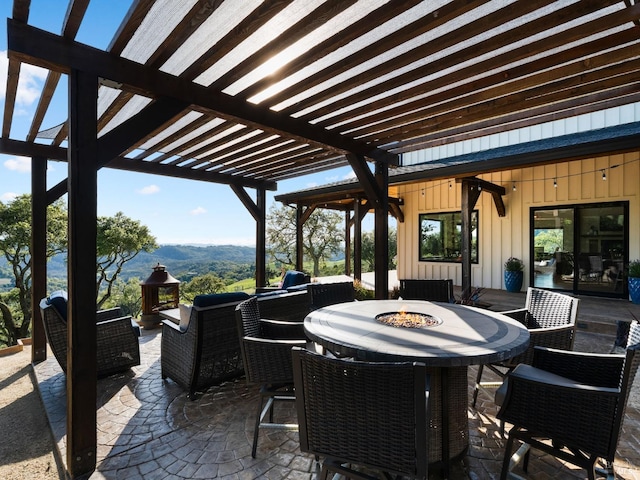 view of patio featuring a pergola, outdoor dining area, and an outdoor living space with a fire pit