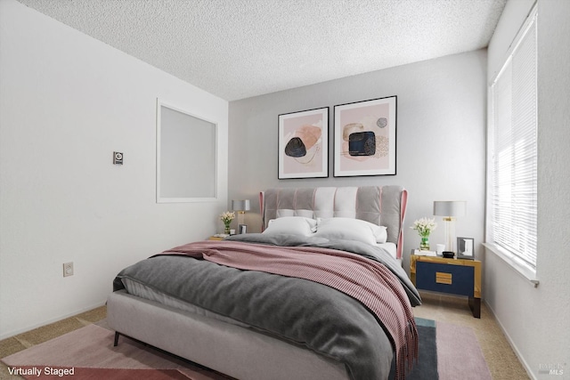 bedroom featuring light carpet and a textured ceiling