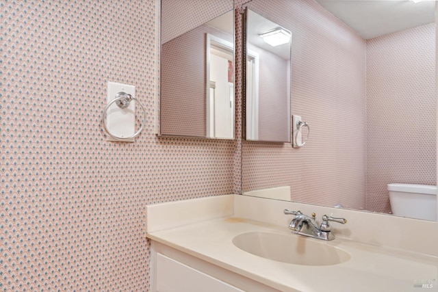 bathroom featuring vanity and toilet