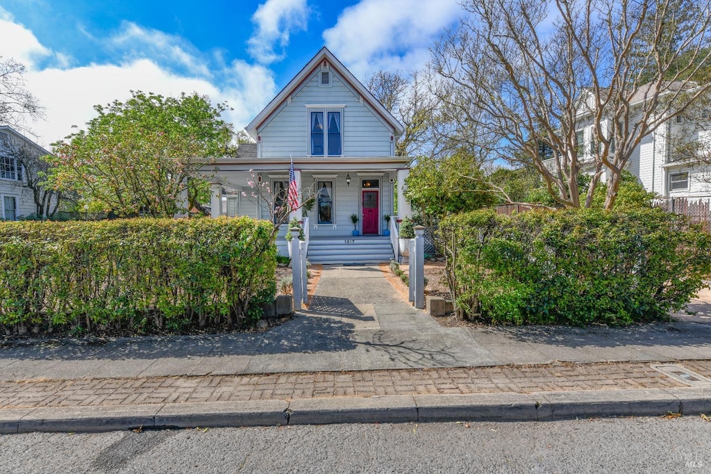 view of front of house featuring a fenced front yard and covered porch
