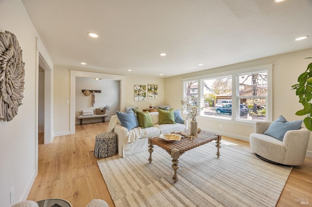 living room featuring recessed lighting, light wood finished floors, and baseboards