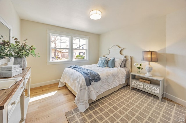 bedroom with light wood-style floors and baseboards