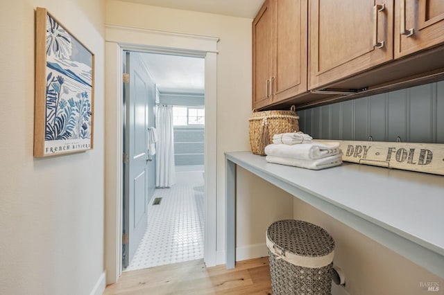 laundry area featuring light wood finished floors and visible vents