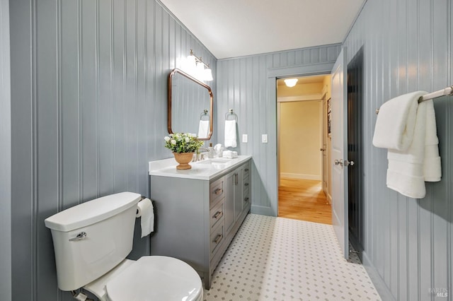 bathroom featuring tile patterned floors, vanity, and toilet