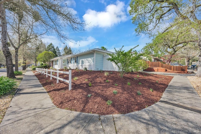 view of home's exterior featuring fence