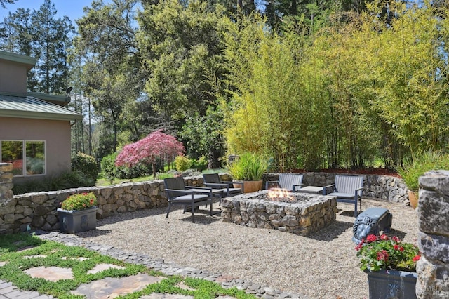view of patio / terrace featuring an outdoor fire pit