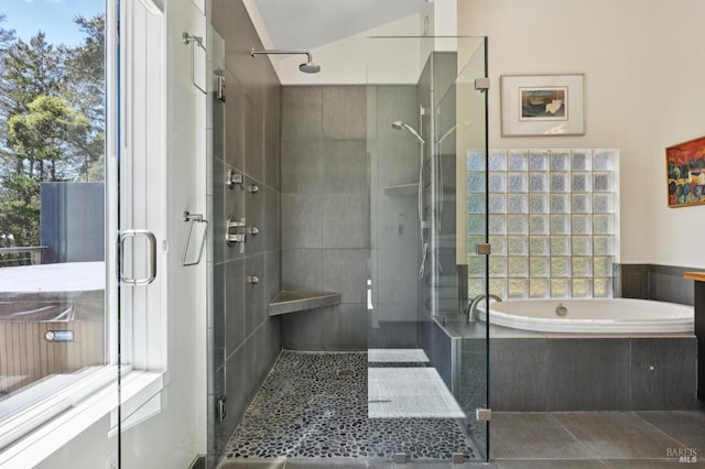 bathroom with a bath, a stall shower, and tile patterned flooring