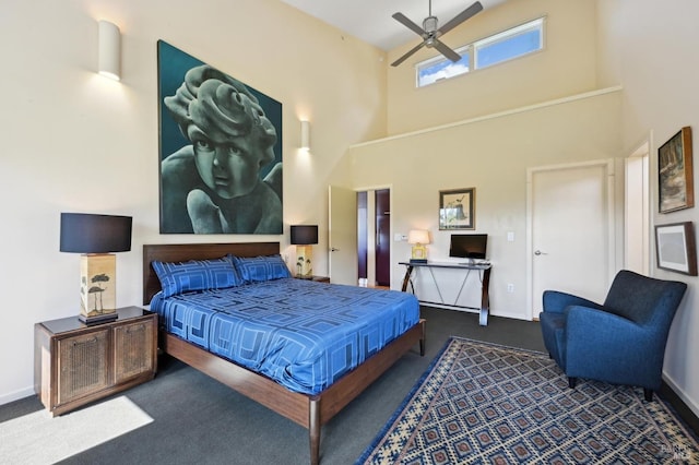 bedroom with carpet floors, baseboards, a ceiling fan, and a towering ceiling