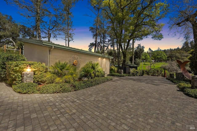 property exterior at dusk with stucco siding