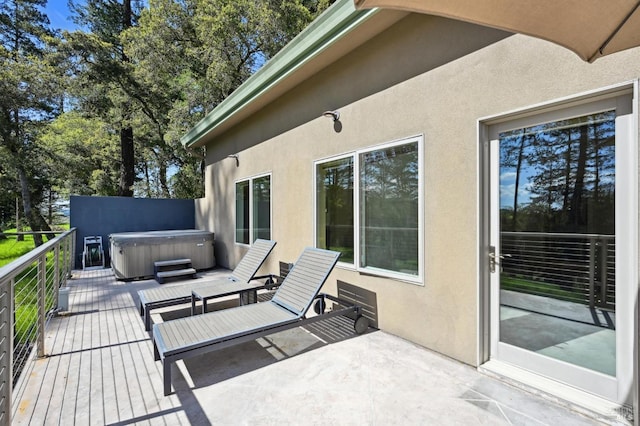 view of patio featuring a deck and a hot tub