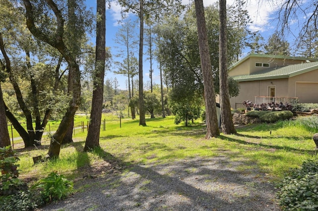 view of yard featuring fence and a garage