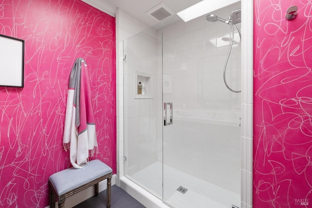 full bathroom featuring a shower stall and visible vents