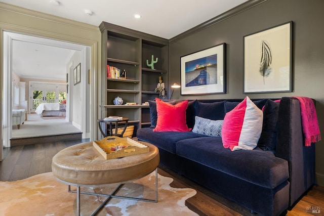 living area with crown molding and wood finished floors