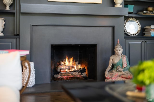 interior details with a lit fireplace