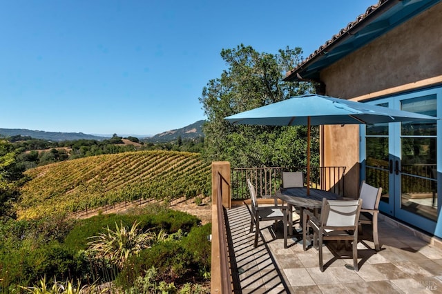 view of patio featuring a mountain view and outdoor dining area